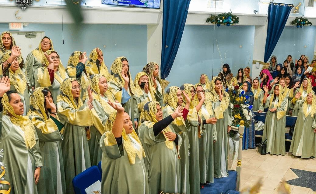 Choir members singing with raised hands